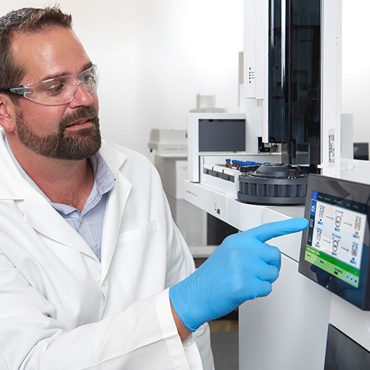 Lab scientist using touch screen on GC