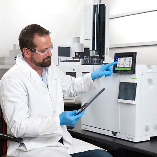 Lab scientist using tablet and GC touch screen