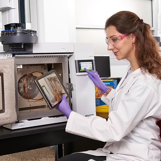 Scientist in lab with Agilent 8860 GC