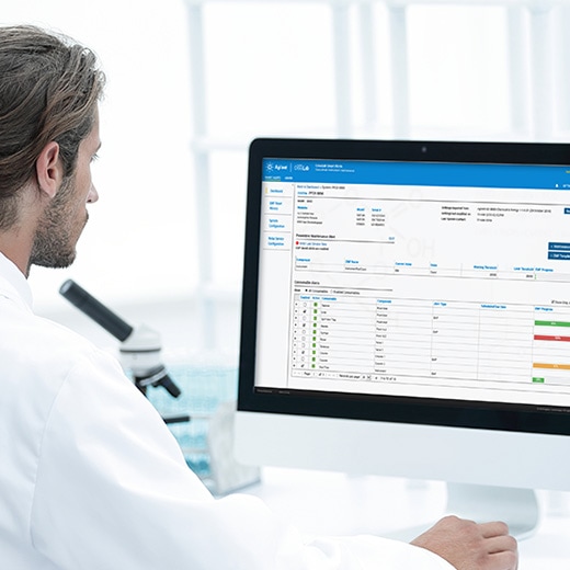 Scientist at computer displaying Agilent CrossLab Smart Alerts software